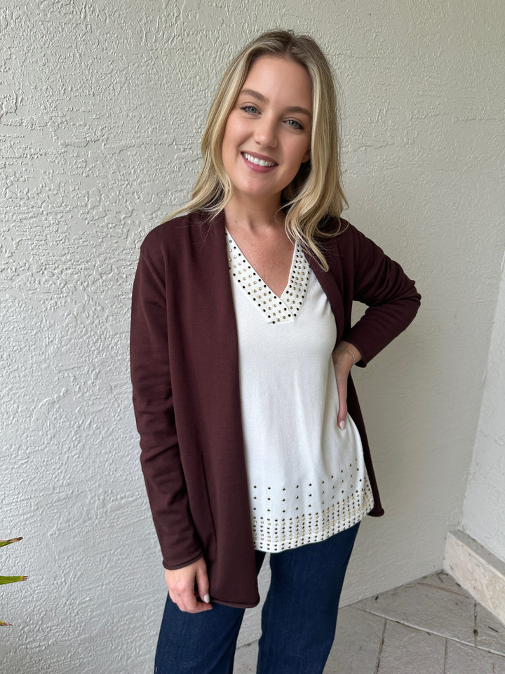 Leo & Ugo V-Neck Rhinestone Grommet Top in White layered with brown cardigan, paired with MAC Indigo Dark Dream Wide Jeans, all available at Barbara Katz