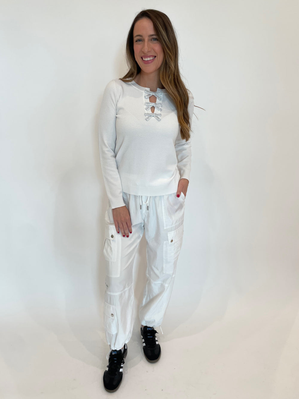 Leo & Ugo Larisa Bow Crystal Sweater in White paired with Cinq a Sept Nitsan Parachute Pants in White available at Barbara Katz