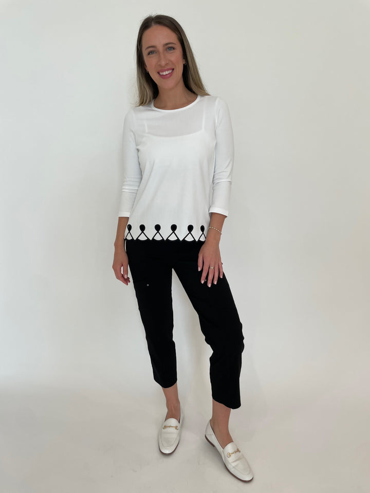 E.L.I Fany 3/4 Sleeve Top With Embroidered Trim in White/Black paired with Elliott Lauren Black Crop Cargo Pants available at Barbara Katz