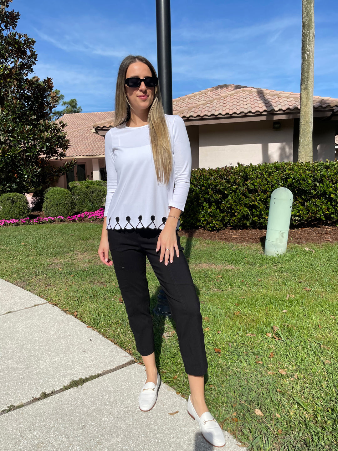 E.L.I Fany 3/4 Sleeve Top With Embroidered Trim in White/Black paired with Elliott Lauren Black Crop Cargo Pants available at Barbara Katz