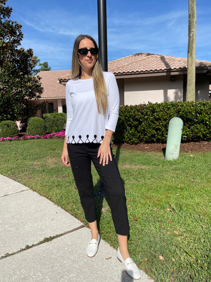 E.L.I Fany 3/4 Sleeve Top With Embroidered Trim in White/Black paired with Elliott Lauren Black Crop Cargo Pants available at Barbara Katz