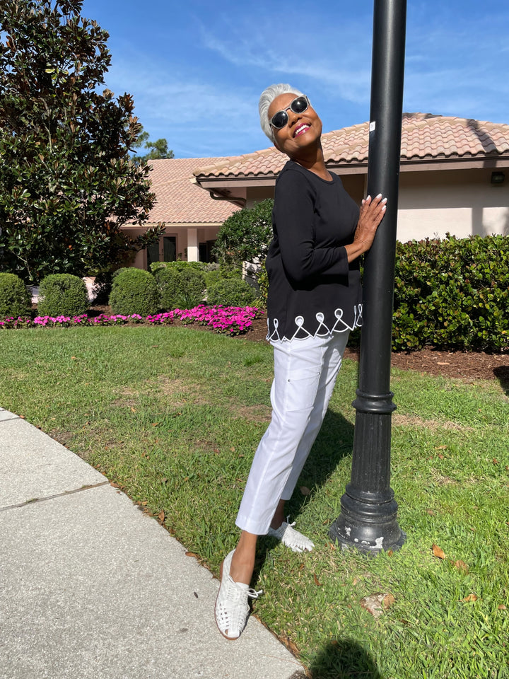 E.L.I Fany 3/4 Sleeve Top With Embroidered Trim in Black/White paired with Elliott Lauren Crop Cargo Pants in White available at Barbara Katz