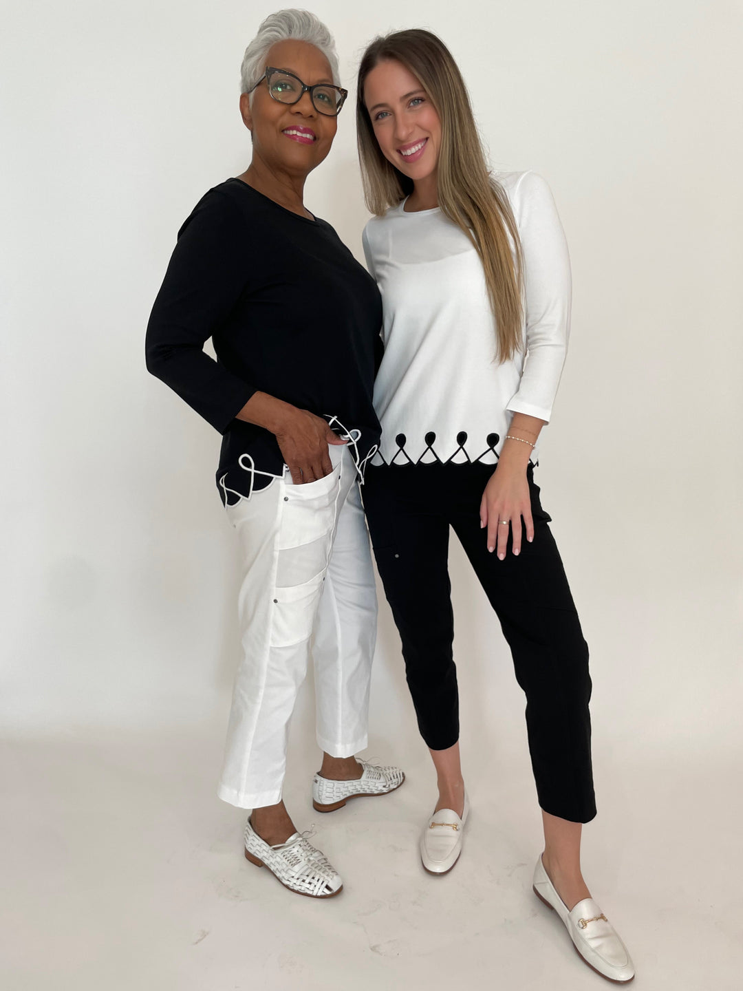 E.L.I Fany 3/4 Sleeve Top With Embroidered Trim in Black/White paired with Elliott Lauren White Crop Cargo Pants and E.L.I Fany 3/4 Sleeve Top With Embroidered Trim in White/Black paired with Elliott Lauren Black Crop Cargo Pants available at Barbara Katz