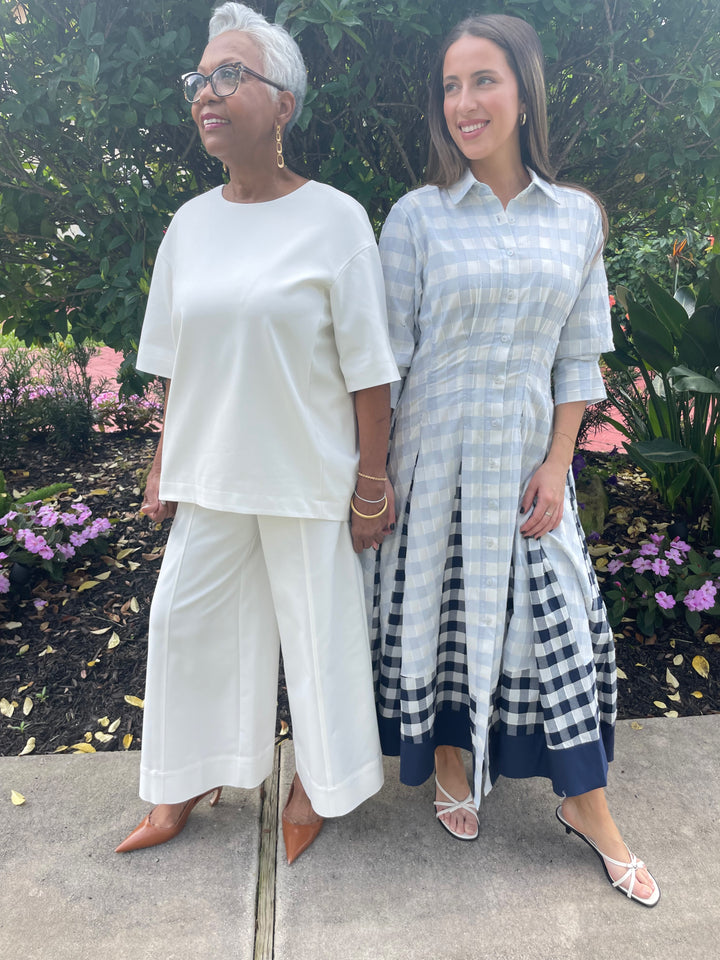 Simkhai Aude Short Sleeve Cotton Top in White paired with matching Kallin Cropped Wide Leg Pants and Simhkai Jazz Pintuck Midi Dress in Periwinkle Sky Multi available at Barbara Katz