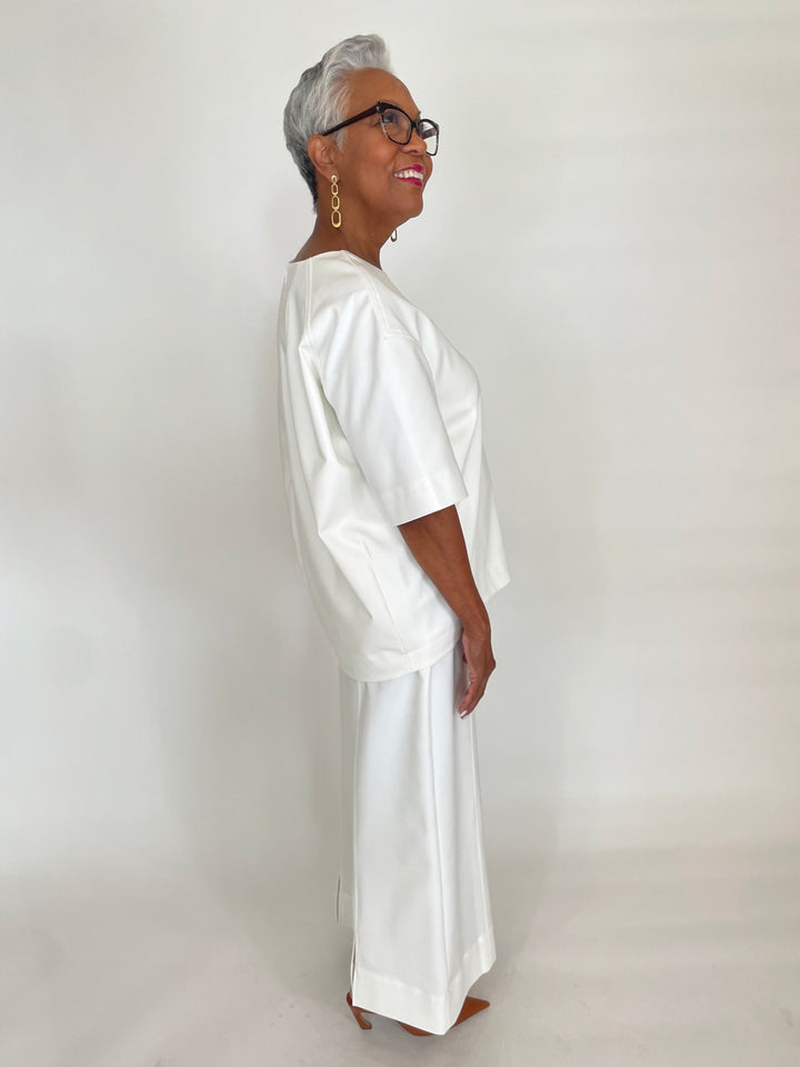 Simkhai Aude Short Sleeve Top in White paired with matching Kallin Cropped Wide Leg Pants available at Barbara Katz