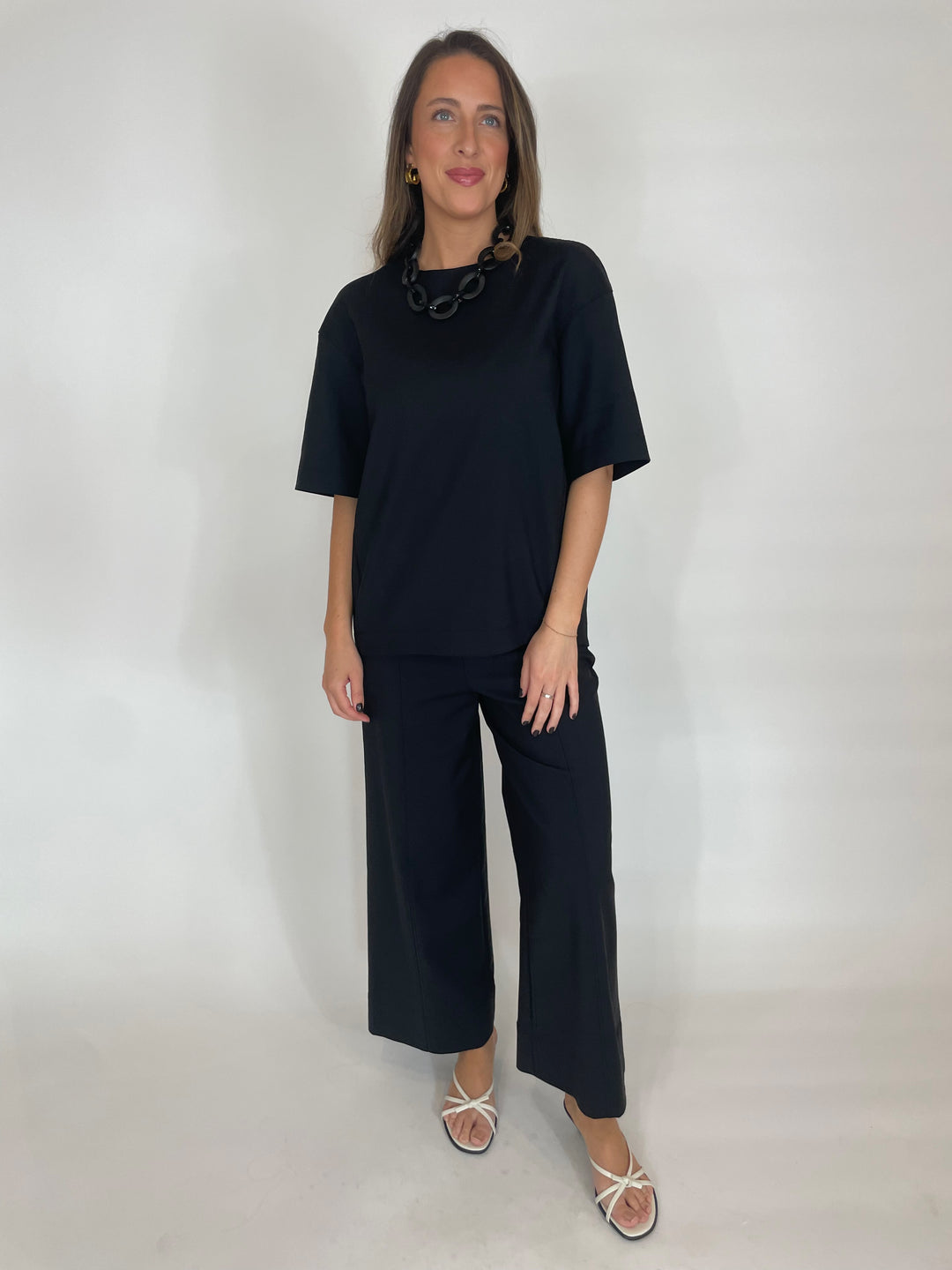 Simkhai Aude Short Sleeve Top in Black paired with matching Simkhai Kallin Cropped Wide Leg Pants in Black  available at Barbara Katz