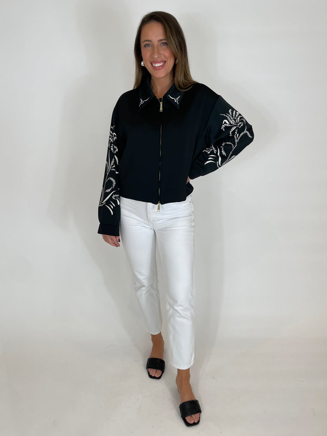 Marella Natalia Satin Blouse in Black Placed paired with White Jeans available at Barbara Katz