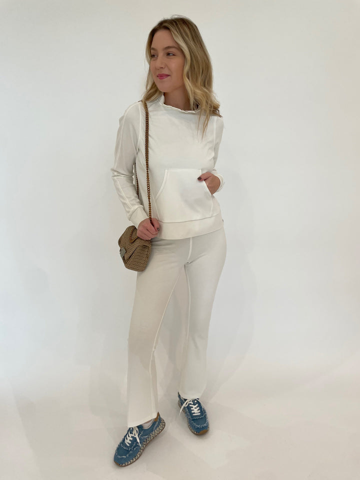 Peace of Cloth Tatum Ruffle Neck Pullover Sweater in Oyster paired with Ella Paramount Knit Pull-On Pants in Oyster, Noam Hazan Mini Milan Bag in Stone available at Barbara Katz