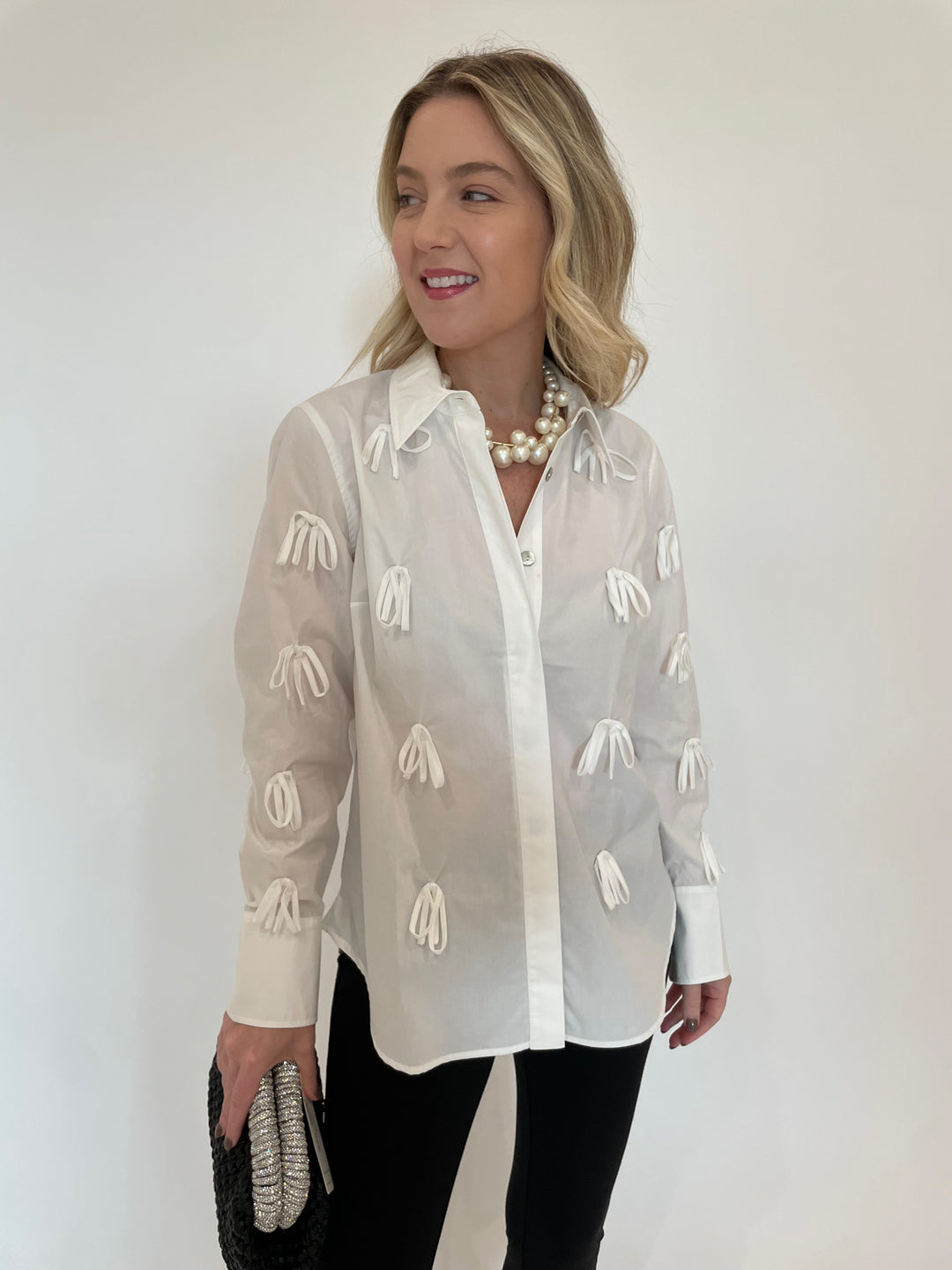 Hope For Flowers Bow Button Down Shirt in White with Vanessa Baroni Multi Beads Collar Necklace in Pearl, Noam Hazan Metallic Desor Clutch in Black available at Barbara Katz