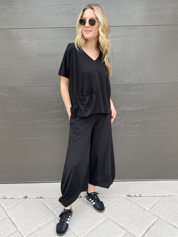 Ozai N Ku Ava V-Neck Pocket Top in Black paired with matching Ozai N Ku Lana Lantern Pants in Black available at Barbara Katz