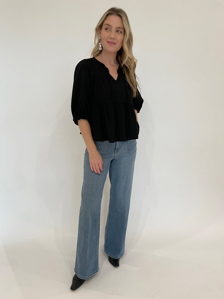 BK Ferlita Elbow Sleeve V-Neck Blouse in Black paired with Frame Le Slim Palazzo Bardot Pocket Jeans in Wilson Clean, Vanessa Baroni Organic Shaped Earrings in Silver available at Barbara Katz