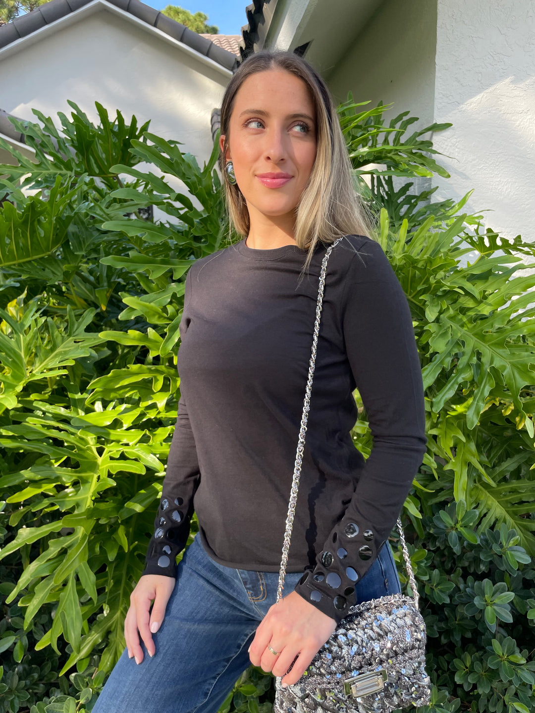 Suzy T Stud T-Shirt in Black paired with Frame Le Slim Palazzo Raw After Jeans in Lupine, Ben Amun Silver Round Clip-On Earrings, Lorenza Gandaglia Corolle 1 Two Tones Bag in Dark Grey Combo
 available at Barbara Katz