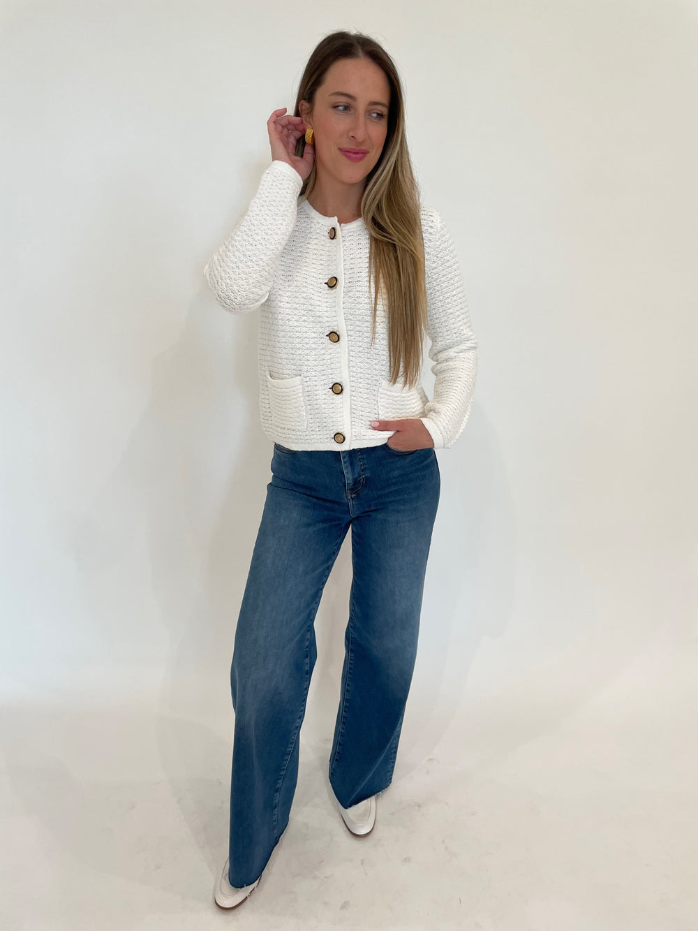 Elliott Lauren Top Priority Button Front Cardigan in White paired with Frame Le Slim Palazzo Raw Fray Jeans in Mermaid, Ben Amun Ribbed Clip-On Earrings in Gold available at Barbara Katz