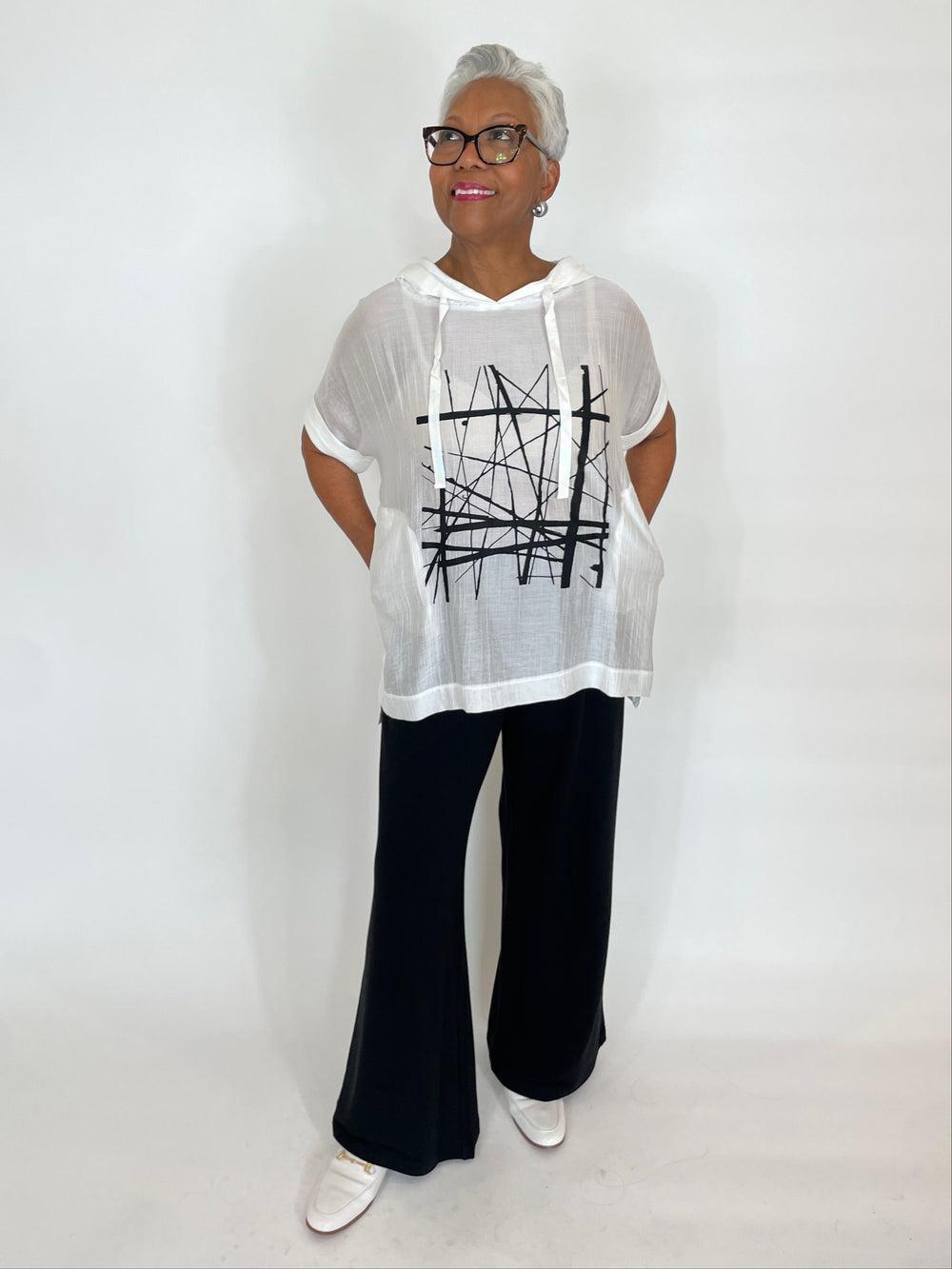 Terra Roxana Hoodie With Center Graphic in White paired with Pure Amici Lisa Pants in Black available at Barbara Katz