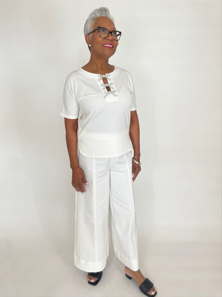 Leo & Ugo Ines Bow Crystal Tee in White paired with Simkhai Kallin Wide Leg Pants in White available at Barbara Katz