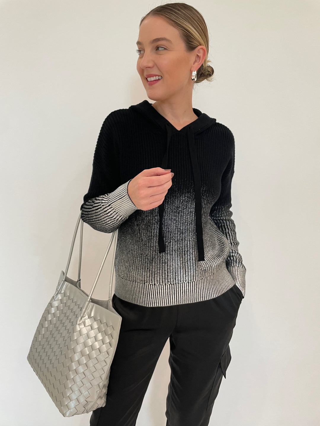 J Society Ombre Metallic Shaker Hoodie in Black paired with J Society Satin Cargo Pants in Black, Lizzie Fortunato Onda Hoops in Silver, BK Victoria Medium Tote Bag in Silver available at Barbara Katz