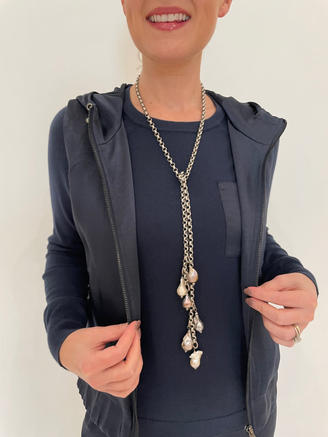 J Society Celeste Satin Hoodie Vest in Navy with Jette Satin Pocket Sweatshirt underneath, Suzy T Pearl Lariat Necklace in Antique Silver available at Barbara Katz