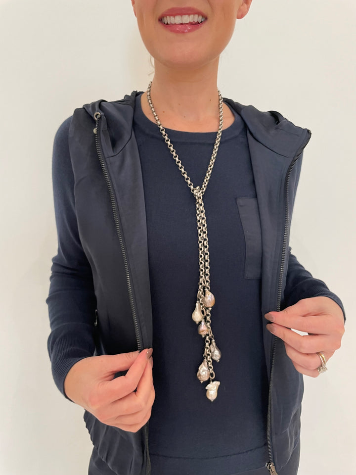 J Society Celeste Satin Hoodie Vest in Navy with Jette Satin Pocket Sweatshirt underneath, Suzy T Pearl Lariat Necklace in Antique Silver available at Barbara Katz