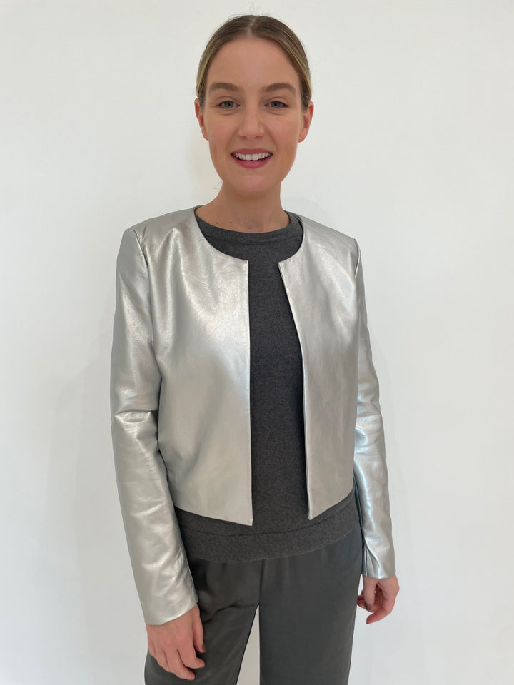 J Society Silver Metallic Collarless Jacket with J Society Gunmetal Satin Pocket Sweatshirt underneath, paired with J Society Gunmetal Satin Pants available at Barbara Katz