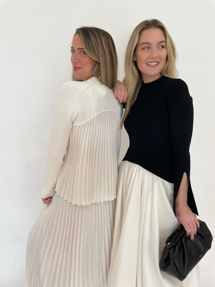 Simkhai Kenlie Long Sleeve Mock Neck Midi Dress in Black Multi with DeMellier Miami Clutch in Black, Simkhai Maeve Pullover Top and Valor Midi Skirt in Ivory - all available at Barbara Katz