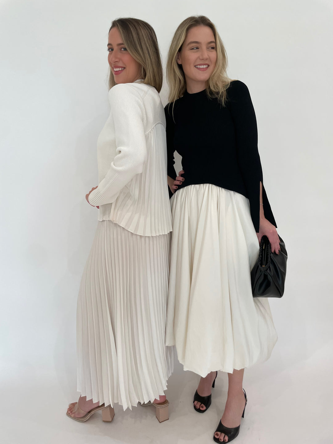 Simkhai Maeve Pullover Top and Valor Midi Skirt in Ivory and Simkhai Kenlie Long Sleeve Mock Neck Midi Dress in Black Multi with DeMellier Miami Clutch in Black - all available at Barbara Katz