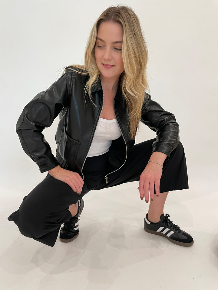 Melisssa Nepton Dona Faux Leather Bomber Jacket in Black with Goldie White Pointelle Cami underneath, paired with Raffaello Rossi Sally 7/8 High Tech Jersey Pants in Black available a Barbara Katz