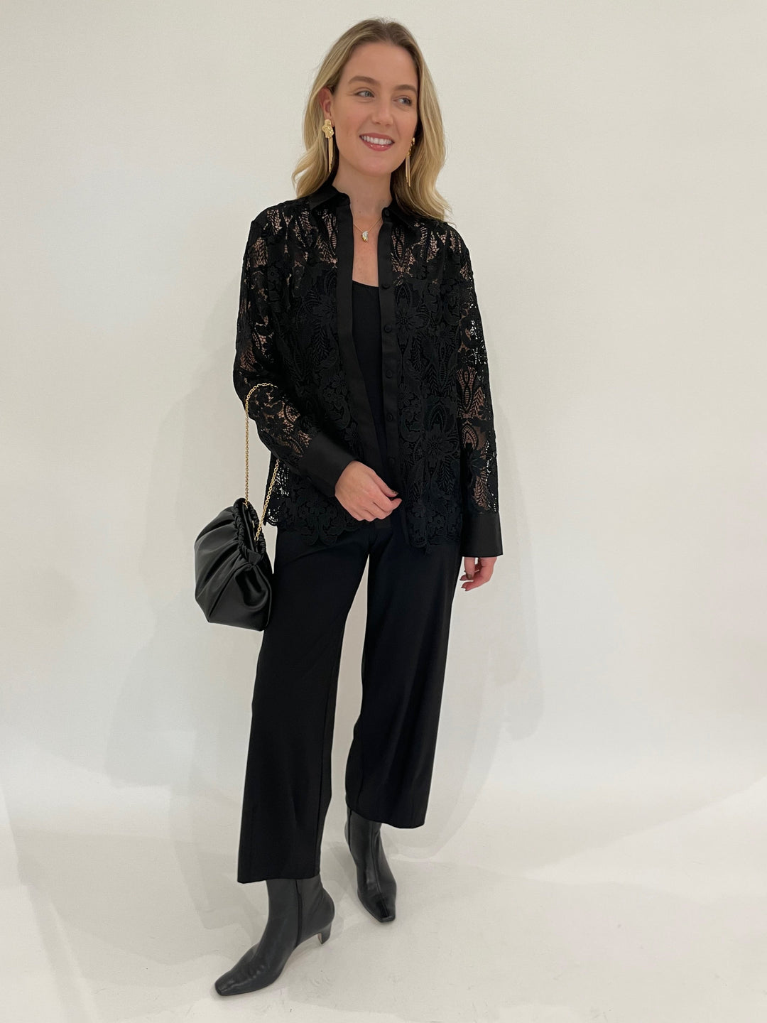 Hinson Wu Margot Long Sleeve Lace Shirt Jacket in Black paired with Raffaello Rossi 7/8 Pants in Black, BK Melanie Gold Hammered Organic & Fringe Earrings, DeMellier Miami Clutch in Black - all available at Barbara Katz