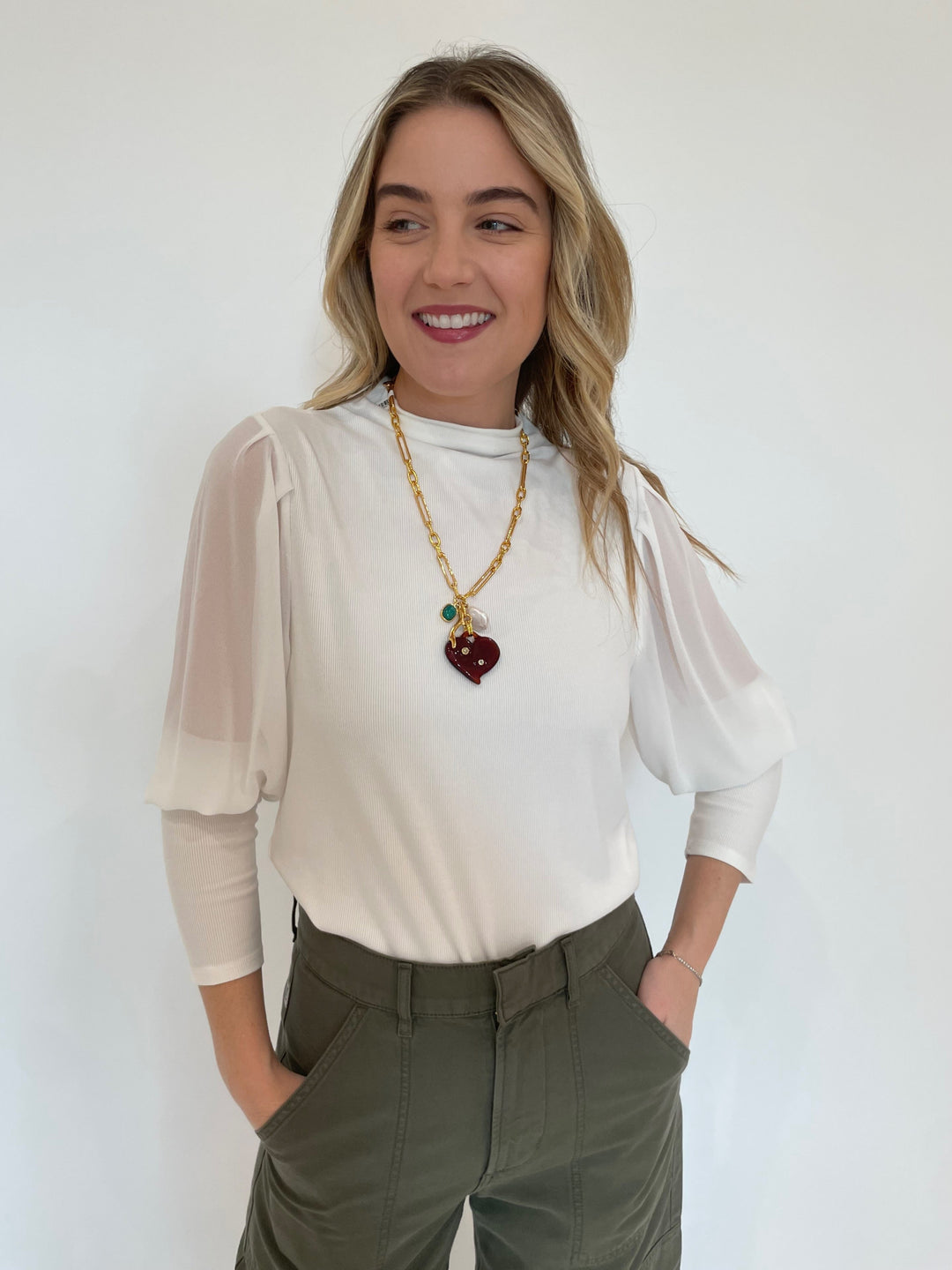 Melissa Nepton Melody Sheer Sleeve Top in Off White paired with Citizens of Humanity Marcelle Low Slung Easy Cargo Pants in Dogwood, Lizzie Fortunato Murano Heart Necklace - all available at Barbara Katz