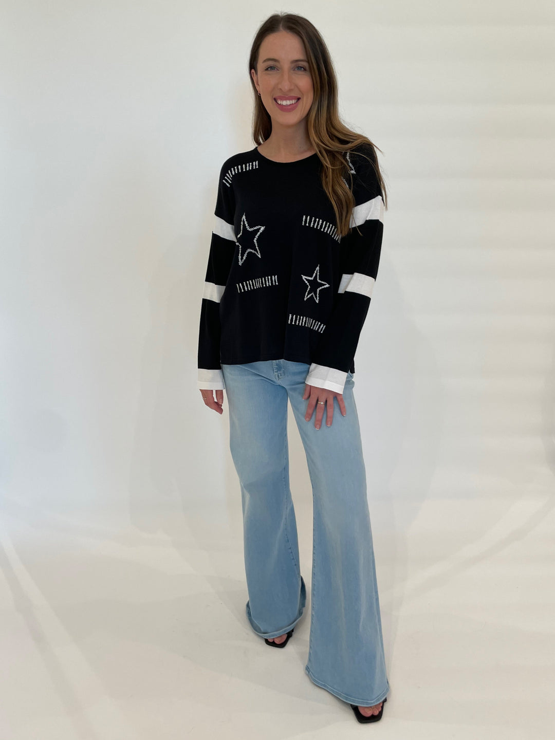 BK Rami Star Sweater in Black/White paired with Mother Denim The Roller Sneak Jeans in Ball's In Your Court available at Barbara Katz