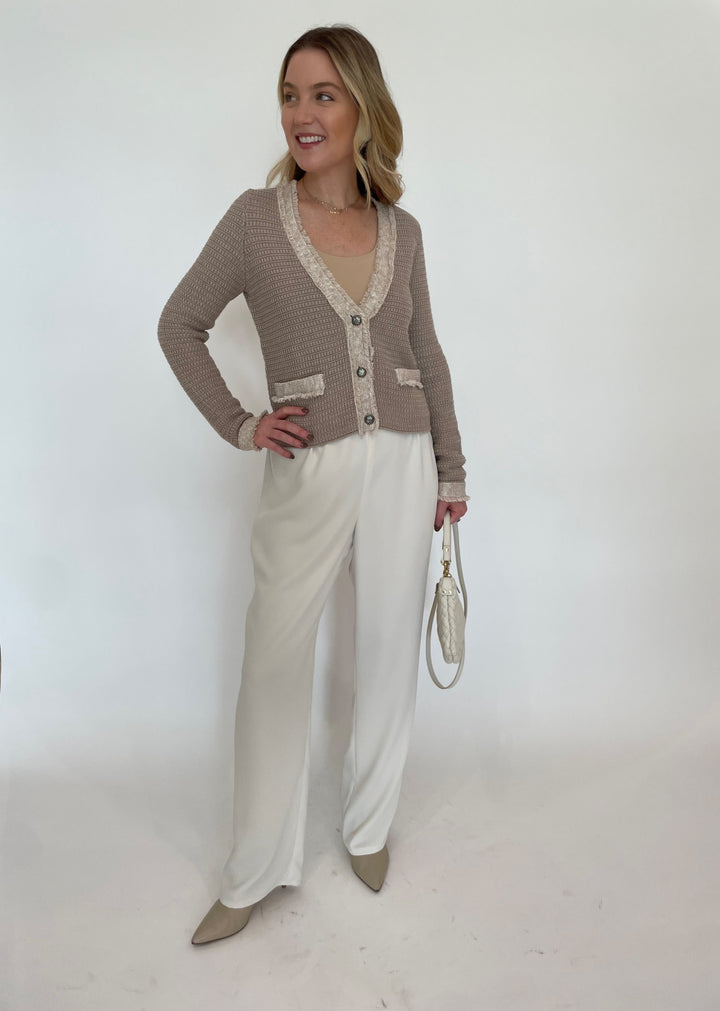 Autumn Cashmere Fringed Trimmed V-Neck Jacket in Sandalwood Combo paired with Peace of Cloth Jules Paramount Knit Pants in Oyster, Clare V  Petit Moyen Messenger Bag in Cream Puff Woven available at Barbara Katz