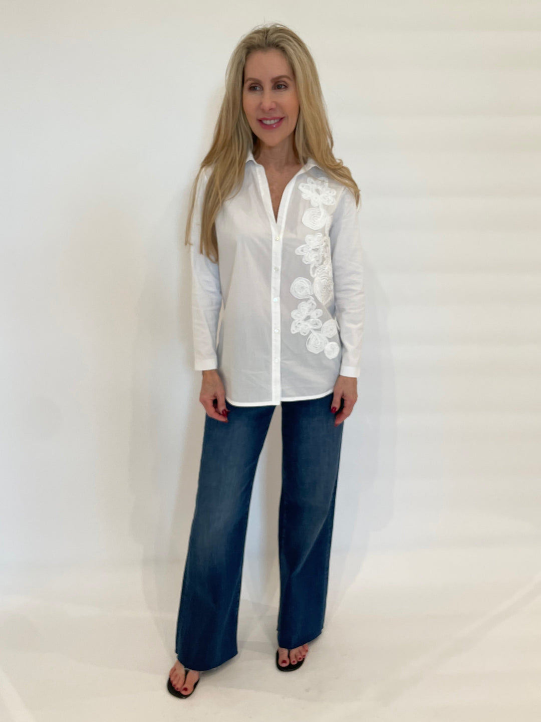 WHYCI Norma Embroidered Flower Shirt in White paired with Frame Denim Le Slim Palazzo Raw After Jeans in Lupine available at Barbara Katz