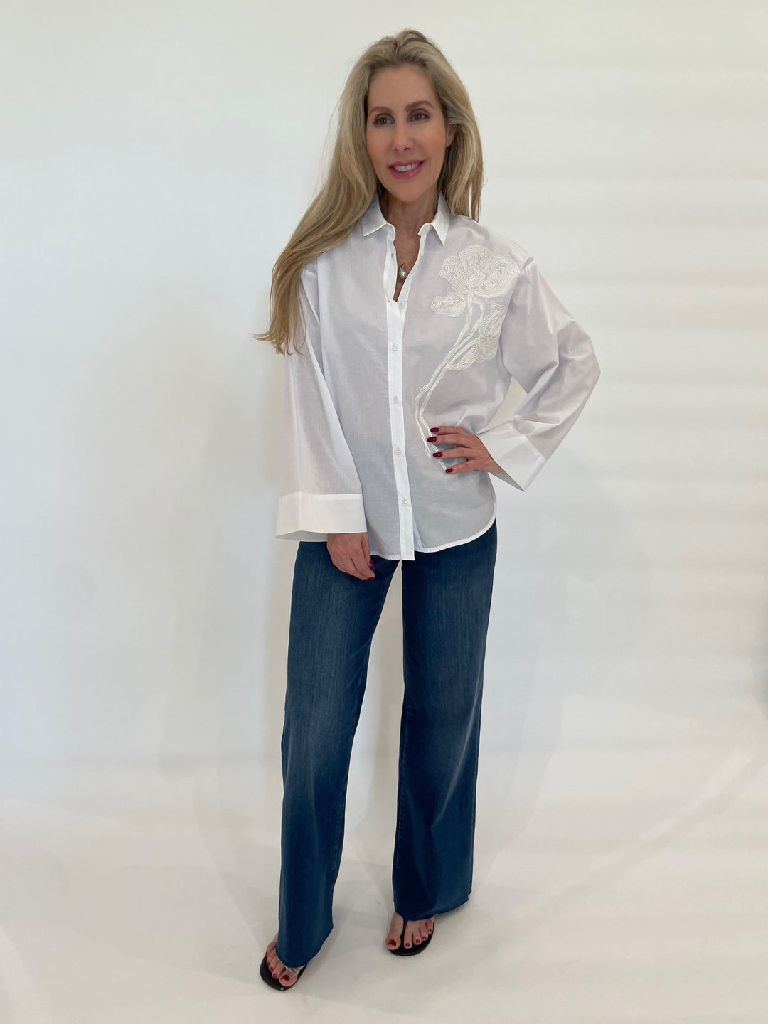 WHYCI Noam Embroidered Shirt in White paired with Frame Denim Le Slim Palazzo Raw After Jeans in Lupine available at Barbara Katz