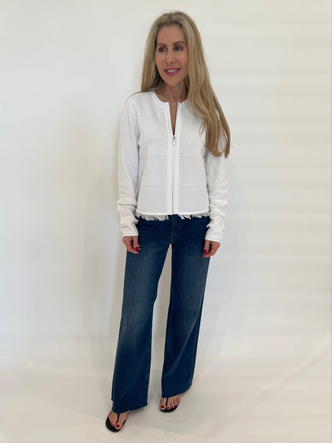 Kinross Fringe Zip Cardigan in White paired with Frame Denim Le Slim Palazzo Jeans in Lupine available at Barbara Katz