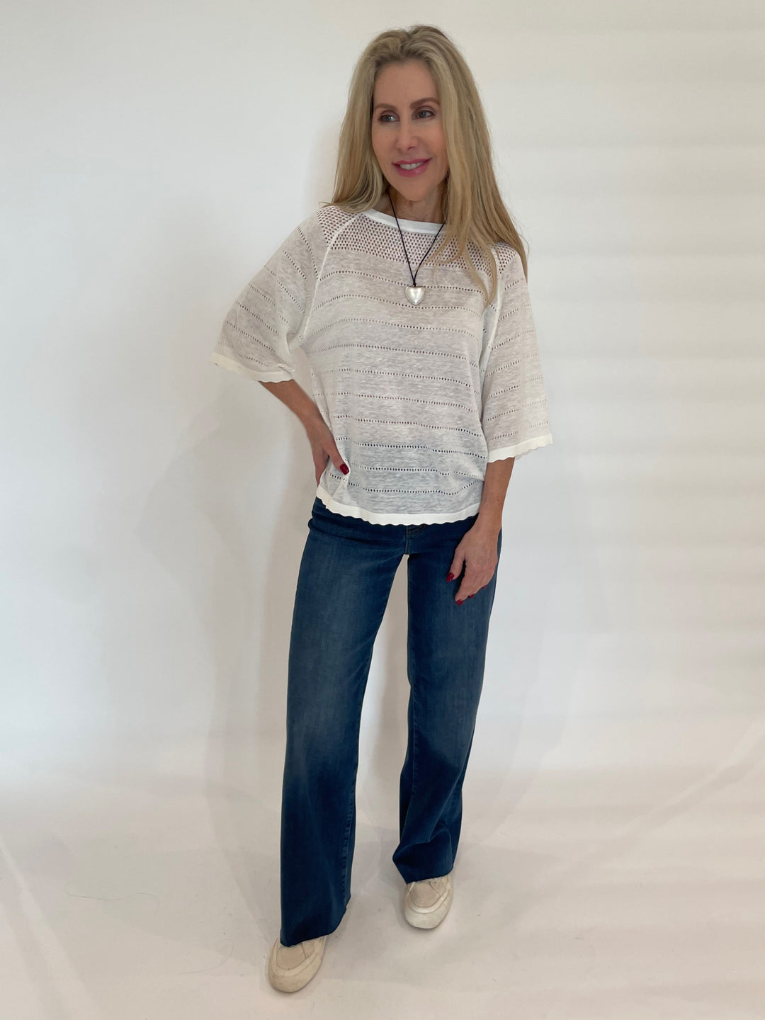 Kinross Hanna Openwork Raglan Crew Sweater in White paired with Frame Denim Le Slim Palazzo Jeans in Lupine available at Barbara Katz