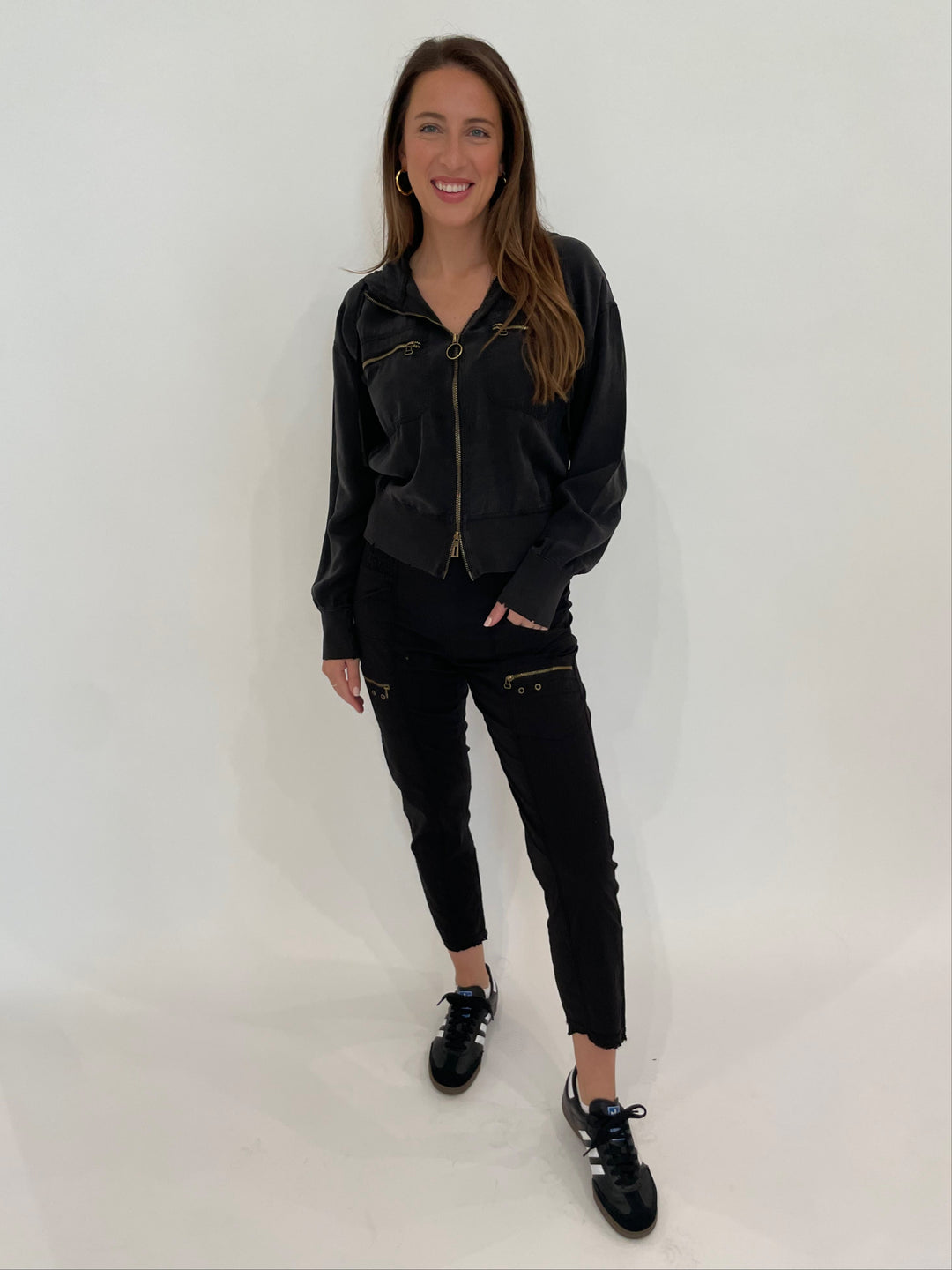 XCVI Darcy Distressed Bomber Jacket in Black paired with XCVI Sunny Cargo Pants in Black available at Barbara Katz