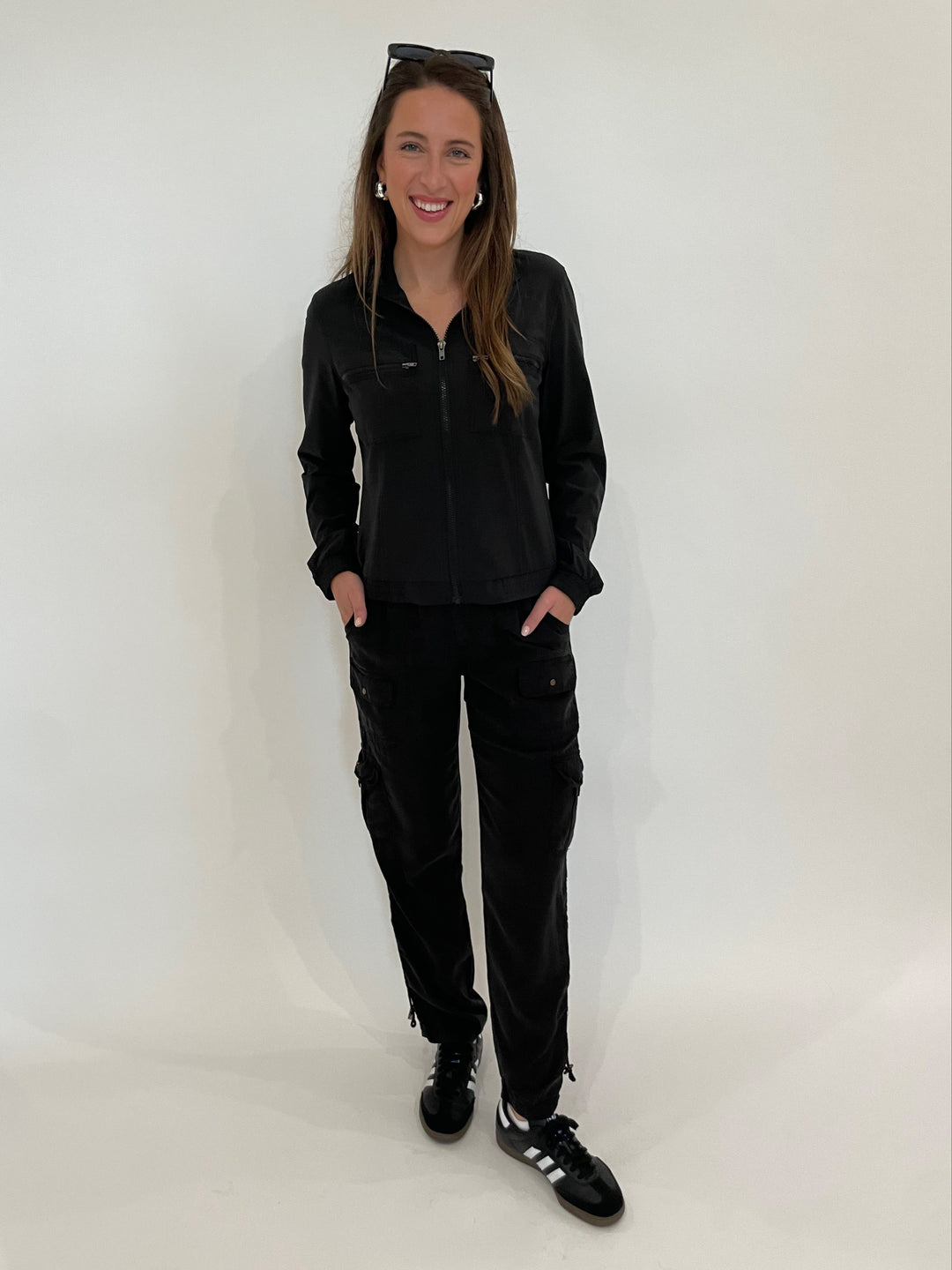 Wearables Active Quinn Bomber Jacket in Black paired with XCVI Sunny Cargo Pants in Black, Lizzie Fortunato Onda Hoop Earrings in Silver available at Barbara Katz