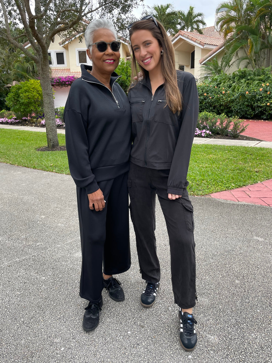 Elliott Lauren Comfort Zone Half-Zip Sweatshirt in Black paired with matching black sweatpants, Wearables Active Quinn Bomber Jacket in Black paired with XCVI Sunny Cargo Pants in Black available at Barbara Katz