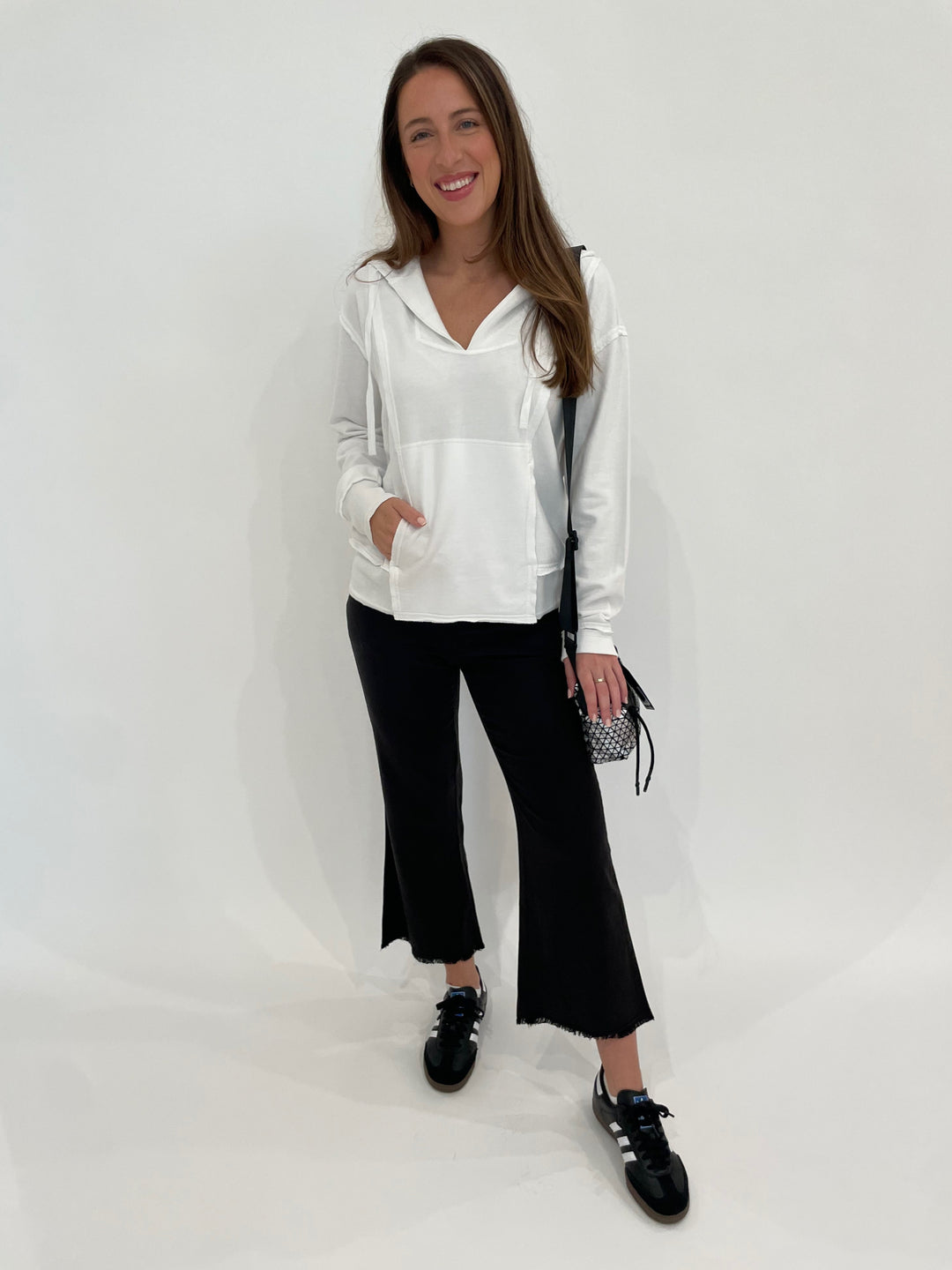 Wearables Ruby Hoodie in White paired with Wearables Lucy Pants in Black, Daniella Lehavi Bonnie Mini Crossbody Bag in Silver available at Barbara Katz