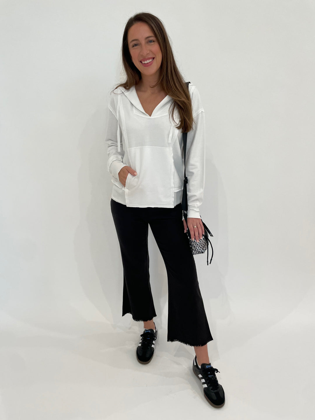 Wearables Ruby Hoodie in White paired with Wearables Lucy Pants in Black, Daniella Lehavi Bonnie Mini Crossbody Bag in Silver available at Barbara Katz