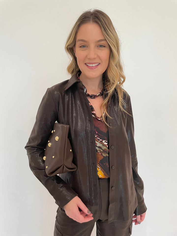 Lysse Connie Patent Foil Vegan Suede Shacket in Liquid Mocha with Lola & Sophie Fairytale Haley Top in Brown 
underneath, Pono Riley Necklace in Hickory, Clare V Georgette Clutch Moto Leather Bag in Chocolate Gold available at Barbara Katz