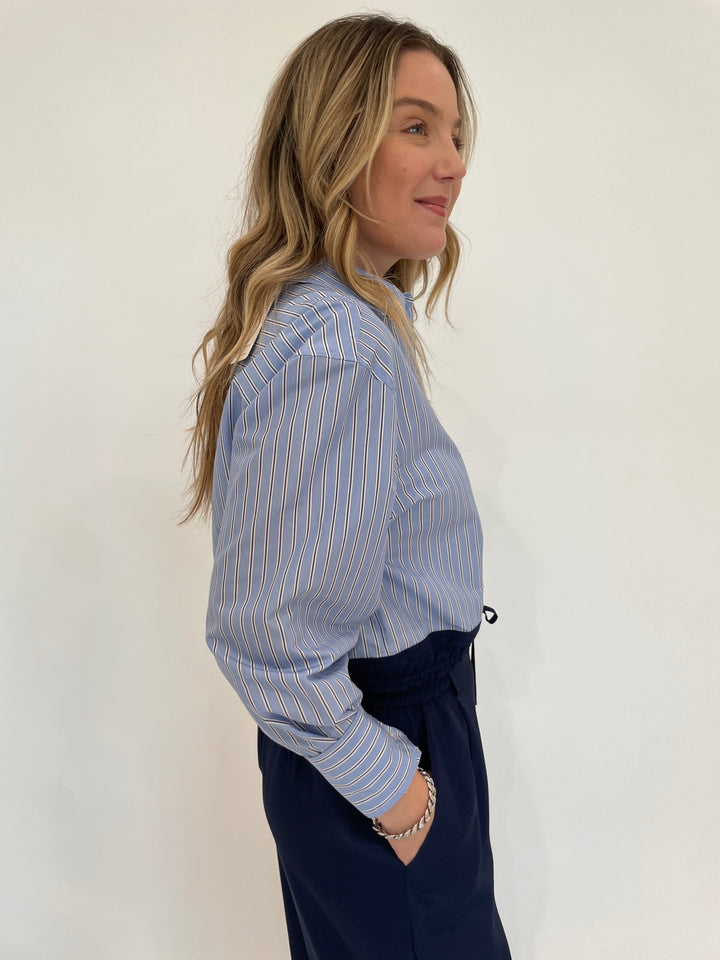 Simkhai Adryck Long Sleeve Shirt in Harbor Blue Stripe paired with SImkhai Sydnie Pleated Pants in Midnight available at Barbara Katz