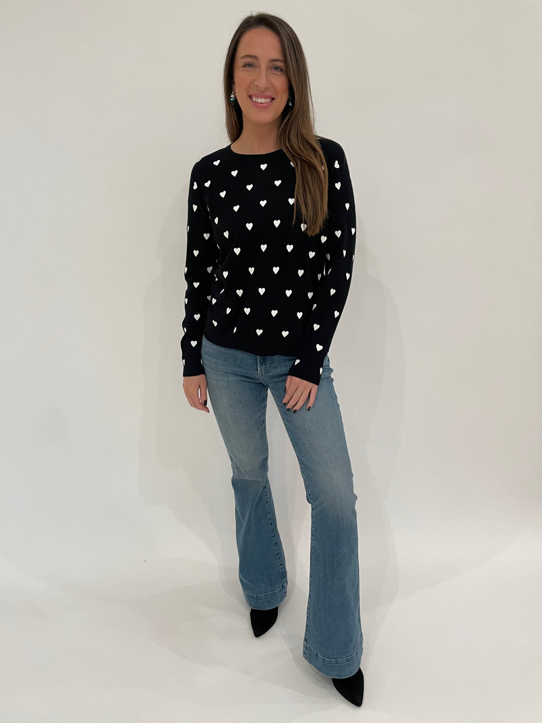 J Society Joy Heart Crew Sweater in Black/White paired with Pistola Denim Kinsley Mid Rise Ultra Flare Jeans in Essay available at Barbara Katz