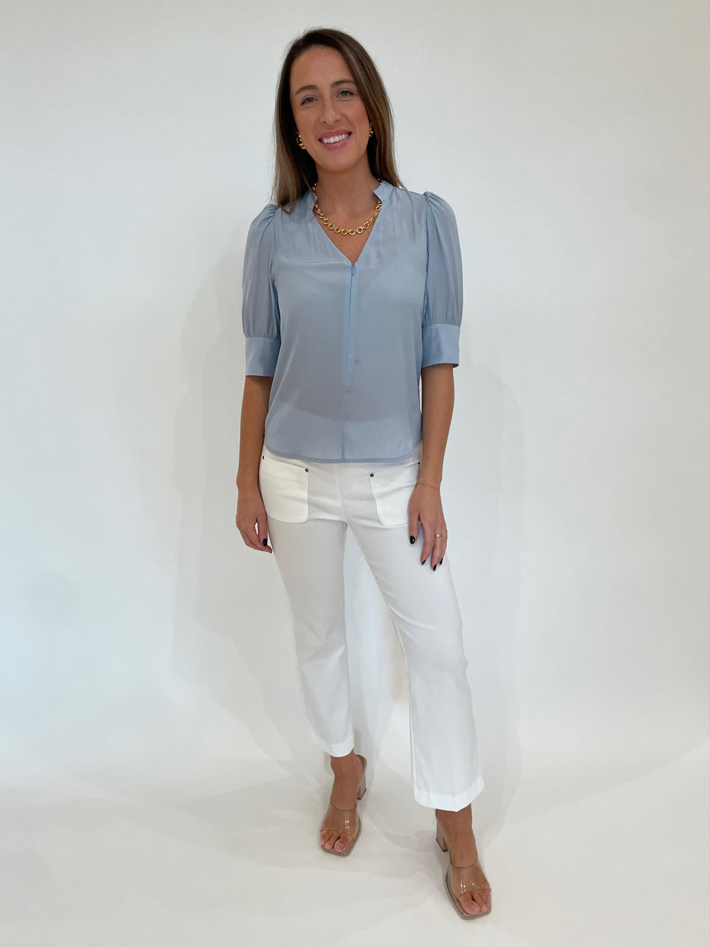 Lola & Sophie Miro Zip Front Blouse in Sky paired with Elliott Lauren Baby Boot Pants in White, Lizzie Fortunato Mood Necklace in Gold, Ben-Amun Madeline Clip-On Link Earrings in Gold available at Barbara Katz