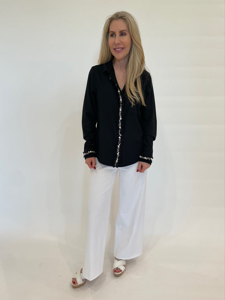 Suzy T Crepe Shirt With Ruffles & Pearls in Black paired with Lysse Erin Hi Waist Wide Leg Jeans in White available at Barbara Katz