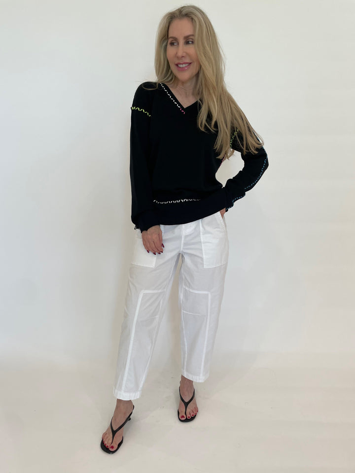 Pure Amici Mona Stitch V-Neck Sweater in Black paired with Marrakech Azure Pants in White available at Barbara Katz