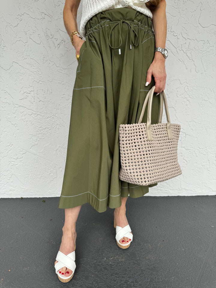 Simkhai Tona Midi Skirt in Army Green, featuring an elasticated waistband with drawstring tie, contrast stitching, mid-calf length, A-line silhouette, dual side pockets, and regular fit