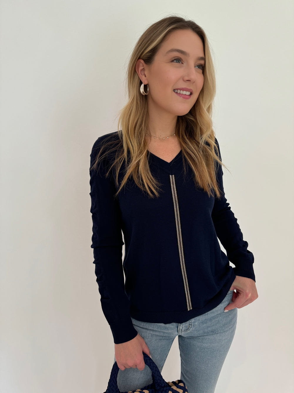 Peace of Cloth V-Neck Sweater With Ribbon Ruched Sleeve in Navy paired with Frame Le Easy Flare Raw Fray Jeans