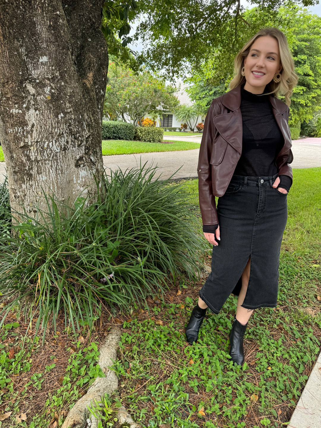 Adroit Atelier Ninon Vegan Leather Jacket in Chocolate with Aldomartins Black Norin Top underneath, paired with Elliott Lauren Geneva Jean Midi Skirt With Front Slit available at Barbara Katz