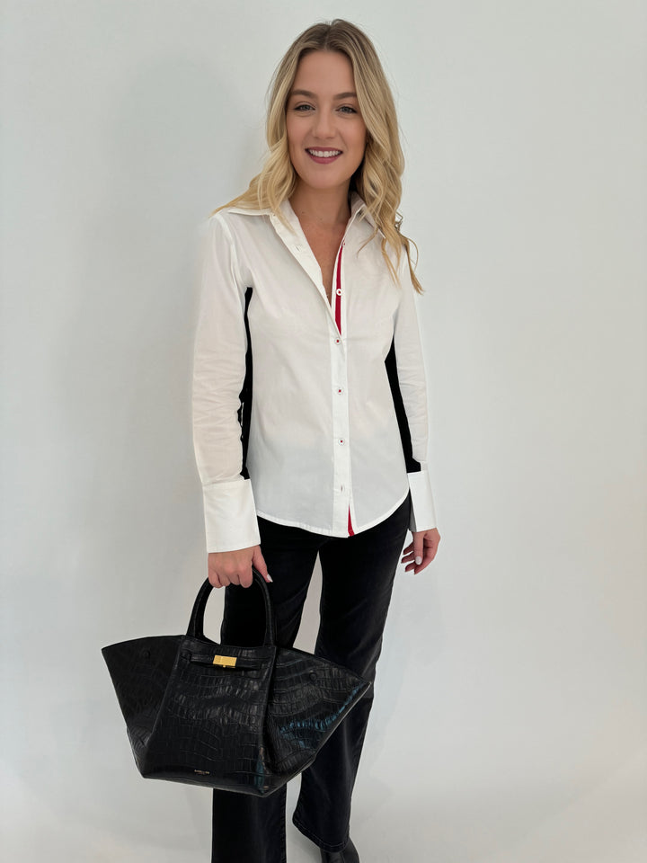 Dizzy-Lizzie Chelsea Shirt in White with Black Side Stripe, paired with Elliott Lauren Black Wide Leg Jeans, shown with bag DeMellier The New York Tote in Black Croc Effect, all available at Barbara Katz