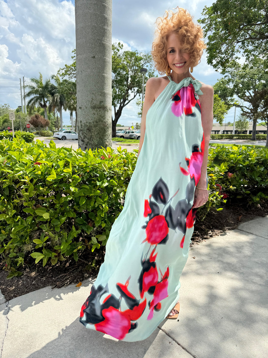 Essentiel Antwerp Fotshot Floral Print Maxi Dress in Light Blue/Fuschia/Red, maxi dress made with mid-weight, non-stretchy fabric, featuring a halter neck, A-line silhouette, watercolor-inspired floral print, and relaxed fit